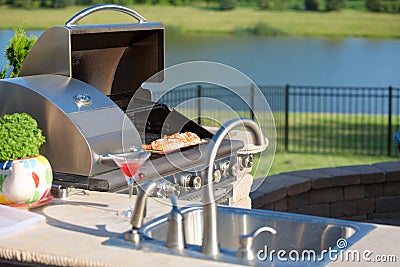 Cooking Cedar Salmon on the Barbecue at the Outdoor Kitchen Stock Photo