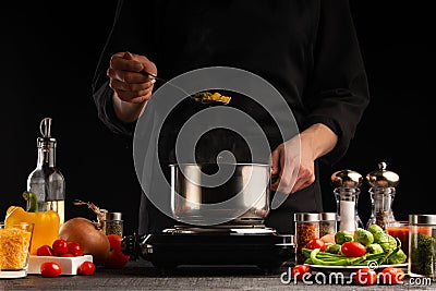 Cooking by the chef in the kitchen. Recipes and cooking, gastronomy. Culinary background. Italian pasta with ingredients Stock Photo