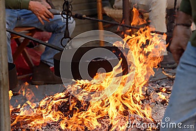 Cooking chestnuts on burning coals Stock Photo
