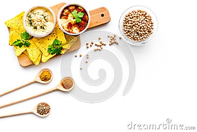 Cooking chickpeas. Bowl with hummus among pieces of crispbread and spices on white background top view copy space Stock Photo