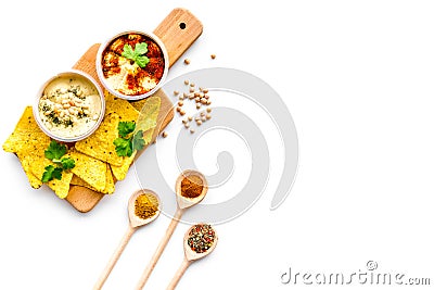 Cooking chickpeas. Bowl with hummus among pieces of crispbread and spices on white background top view copy space Stock Photo