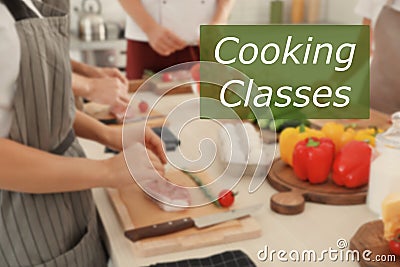 Cooking classes. Blurred view of people preparing meat in kitchen Stock Photo