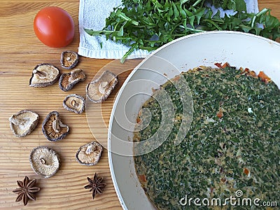 Cooking dandelion leaves omelette with mushrooms Stock Photo