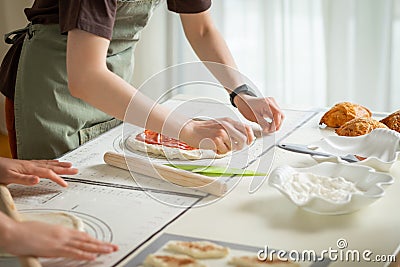 Cooking desserts in a large kitchen by two chefs on silicone kitchen mats Stock Photo
