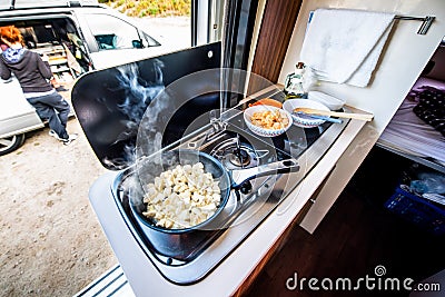 Cooking dinner or lunch in campervan, motorhome or RV Stock Photo