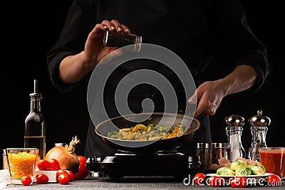 Cooking dishes with meat and vegetables. Oriental cuisine, Asia food. Seasoning, freezing in motion. Vegetables and meat, tasty Stock Photo