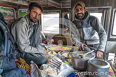 Cooking and eating view with indian drivers inside the truck Editorial Stock Photo