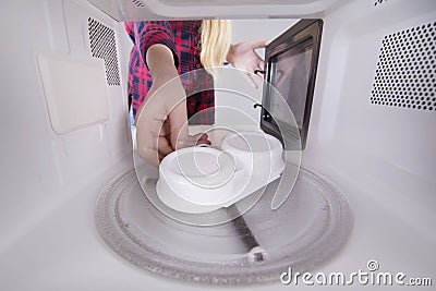 Cooking eggs poacher in your microwave Stock Photo