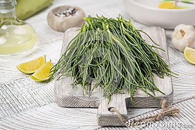 Cooking Fresh Agretti or barba dei frati, edible green plant. Saltwort Stock Photo