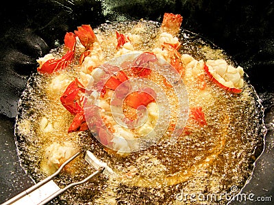 Cooking fried lobster in boiling oil Stock Photo