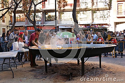 Cooking a giant Paella, traditional Valencian food Editorial Stock Photo