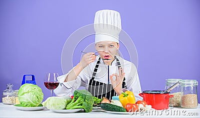 Cooking healthy food. Fresh vegetables ingredients for cooking meal. Professional cooking tips. Woman chef try taste Stock Photo