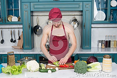 Cooking healthy and tasty food. Bearded man enjoy cooking natural food. Sexy naked chef cook prepare veggies for cooking Stock Photo
