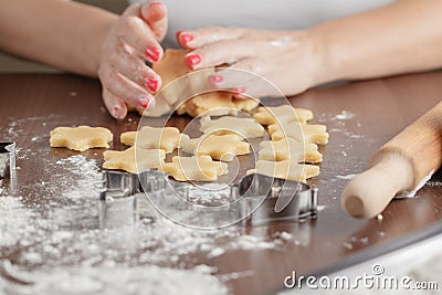 cooking and home concept - close up of female hands making cookies from fresh dough at home Stock Photo