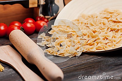 cooking italian pasta by hand kitchen cherry tomatoes ingredients Stock Photo