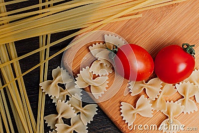 cooking italian pasta by hand kitchen cherry tomatoes ingredients lunch Stock Photo