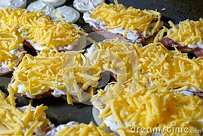 Cooking meat with cheese in French. The meat baked in the oven lies on a black metal baking sheet Stock Photo