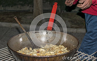 Cooking migas or Crumbs a typical spanish food. Crumbs prepared in a frying pan Stock Photo