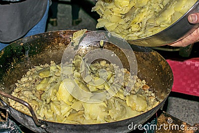 Cooking migas or Crumbs a typical spanish food. Crumbs prepared in a frying pan Stock Photo