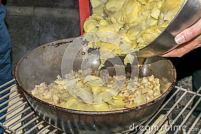 Cooking migas or Crumbs a typical spanish food. Crumbs prepared in a frying pan Stock Photo