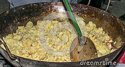 Cooking migas or Crumbs a typical spanish food. Crumbs prepared in a frying pan Stock Photo