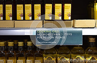 A cooking oil section in a British supermarket with a sign advising each customer can only buy 2 items Editorial Stock Photo