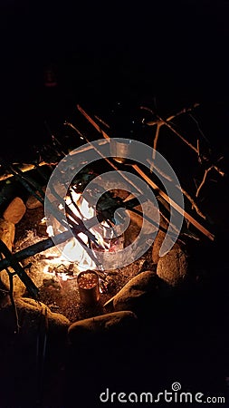 Cooking over a fire at night Stock Photo