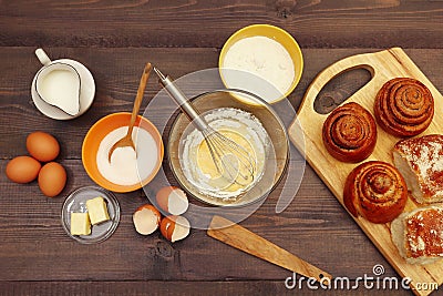 Cooking pastries from ingredients to fresh buns on wooden table. View from above Stock Photo