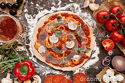 Cooking Pizza. Pizza ingredients on the wooden table, top view Stock Photo