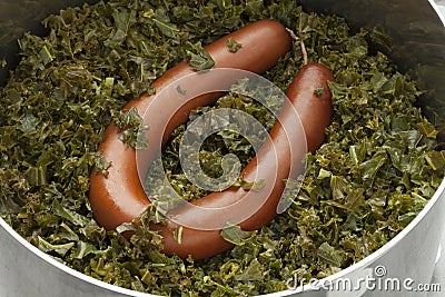 Cooking pot with cooked curly kale and sausage Stock Photo