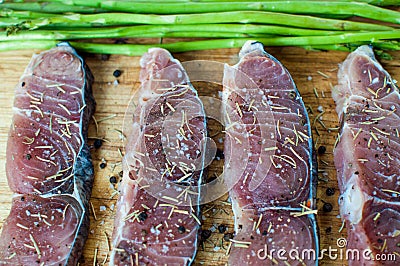 A cooking preparation of raw slices of fish with ingredients Stock Photo