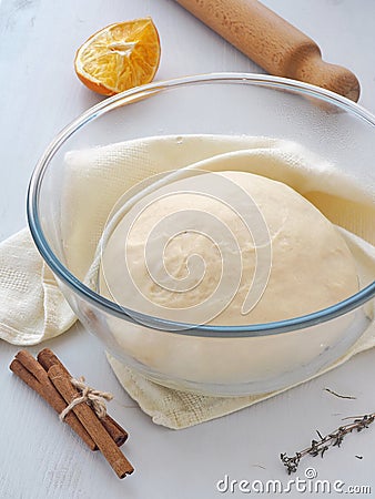 Cooking process. Preparing dough for cakes, pastries, buns or pizza. Leavened dough in misted bowl. Vertical. Stock Photo