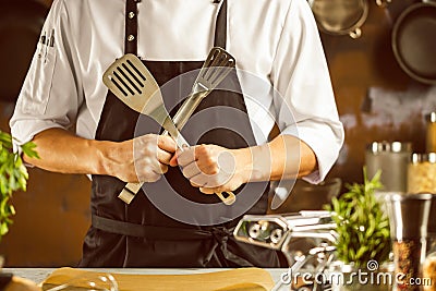 Cooking, profession and people concept - male chef cook making food at restaurant kitchen Stock Photo