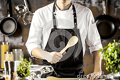 Cooking, profession and people concept - male chef cook making food at restaurant kitchen Stock Photo