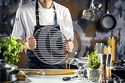 Cooking, profession and people concept - male chef cook making food at restaurant kitchen Stock Photo