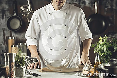 Cooking, profession and people concept - male chef cook making food at restaurant kitchen Stock Photo