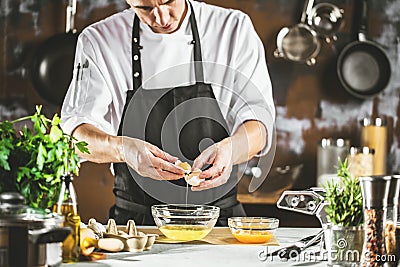 Cooking, profession and people concept - male chef cook making food at restaurant kitchen Stock Photo