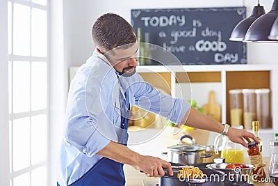 Cooking, profession and people concept - male chef cook with sm Stock Photo