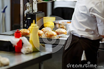 Cooking sesame buns and chef hands in the kitchen Stock Photo