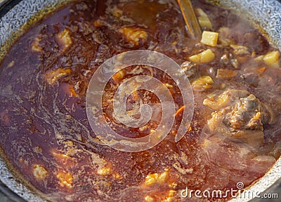 Cooking soup on the grill. Tourist bowler with bograch on the fire Stock Photo