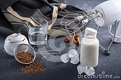 Cooking step-by-step Korean Dalgona coffee. Set of products: instant coffee, milk, ice, water, sugar. Step 1 Stock Photo