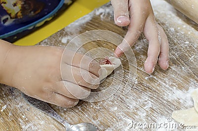 Cooking together with children. Children leaning how to make manti Central Asia dumplings Stock Photo