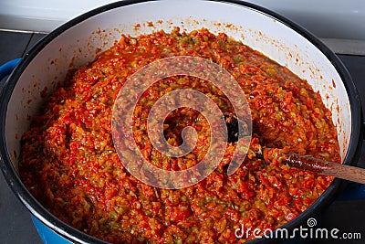 Cooking traditional Balkan food Ajvar on stove in big pot Stock Photo