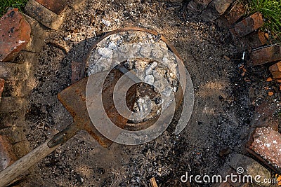 Cooking traditional dalmatian, croatian, bosnian dish called peka. Meat, potatoes and vegetables in pot and covered with hot Stock Photo