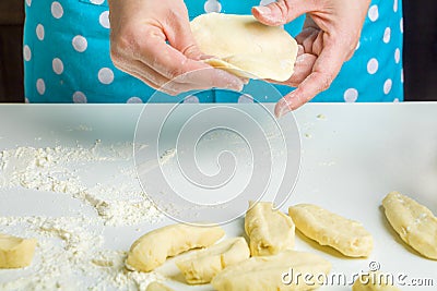 Cooking vegetarian dumplings with mashed potatoes kreplach, jewish ravioli in home kitchen. Step 8 female hands roll out Stock Photo