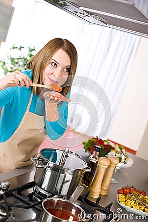 Cooking - Woman tasting Italian tomato sauce Stock Photo