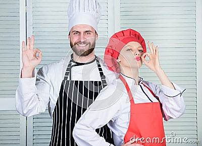 Cooking with your spouse can strengthen relationships. Teamwork in kitchen. Couple cooking dinner. Woman and bearded man Stock Photo