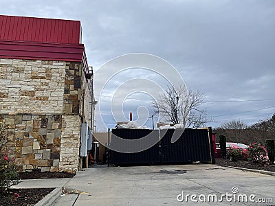 Cookout fast food restaurant building drive thru overflowing trash dumpsters Editorial Stock Photo