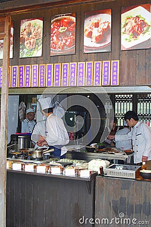 Cooks are preparing meals in a take away restaurant in water town Wuzhen, China Editorial Stock Photo