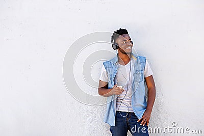 Cool african guy with mobile phone and headphones listening to music Stock Photo